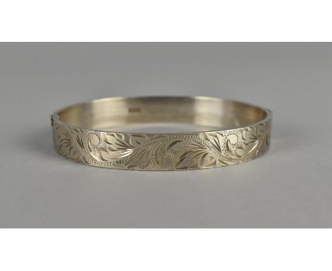 A Silver Bangle by BL ltd, Birmingham 1974, with Floral Decoration 