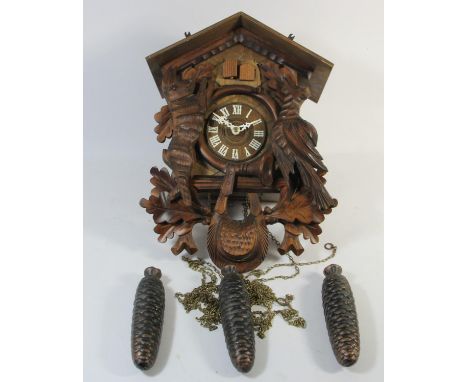 A German carved softwood cuckoo wall clock, with Regula, West Germany movement and Swiss Musical movement, playing Edelweiss,