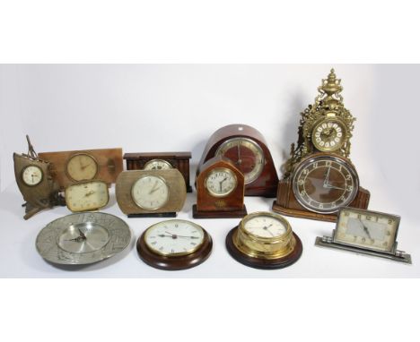 A collection of clocks to include, a gilt metal mantle clock, a wall hanging barometer, an oak cased mantle clock and others 