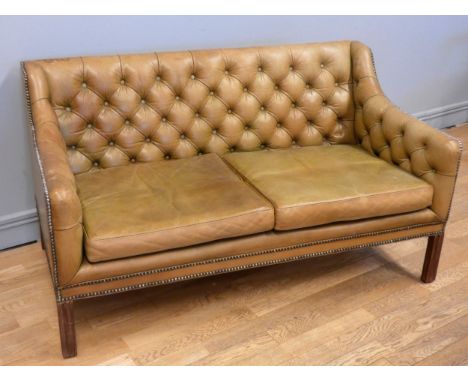 A light tanned leather button backed Chesterfield sofa, with squab cushions, raised on square mahogany legs, 139cm x 76cm x 7