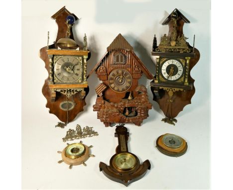 Two mid 20th century mahogany Dutch wall clocks together with a large quartz cuckoo clock, and three barometers, no weights 