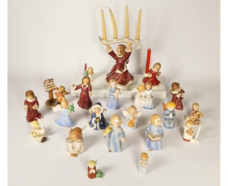 A collection of twenty Goebel angel Christmas ornaments, to include choir singers, candle holders and others 