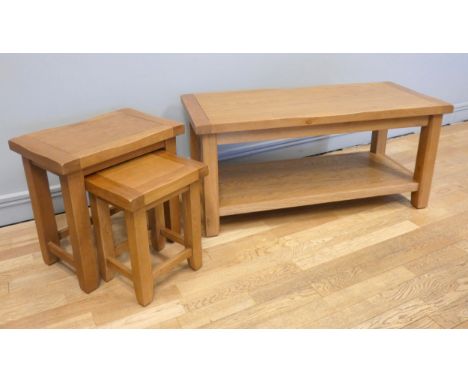 A modern light oak coffee table, with lower shelf, 110cm x 50cm x 50cm, together with a similar nest of two tables, 50cm x 35