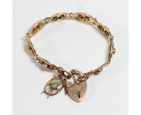 An Art Nouveau rose gold mother of pearl and peridot nine panel link bracelet, in the style of Murrle Bennet, padlock, EGB, B