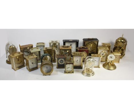 A collection of clocks to include, a Metamec electric clock, oak cased mantle clocks and quartz carriage clocks (2) 