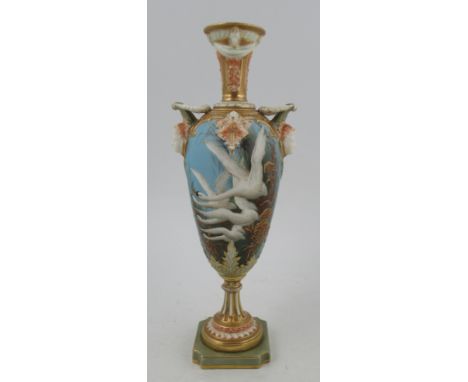 A Royal Worcester pedestal vase, decorated with swans in flight with gilt reeds to a powder blue ground, swallow to the rever