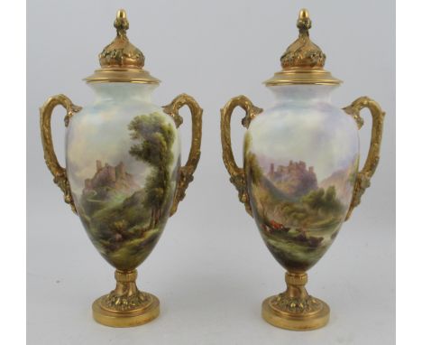 A pair of Royal Worcester covered vases, decorated all round with a castle in landscape, one with cattle to the foreground by