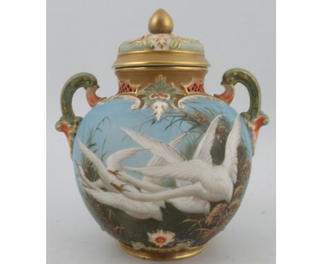 A Royal Worcester covered globular vase, decorated with four swans to a powder blue ground by CHC Baldwyn, having a pair of o
