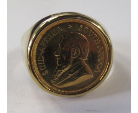 A 9ct ring, set 1/10 oz South African Krugerrand, dated 1990&nbsp;