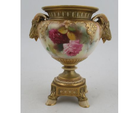 A Royal Worcester vase, the quarter lobed body decorated with roses, with gilt ram mask handles, a pedestal square base and h