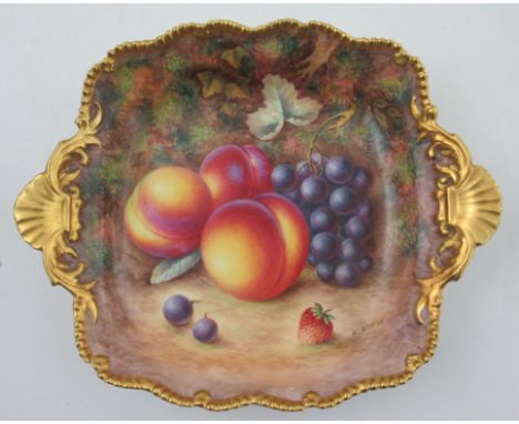 A Royal Worcester square dish, decorated with fruit to a mossy background by H Aryton, with gilt shaped edge and shell handle