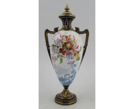 A Royal Worcester covered pedestal vase, decorated with flowers and a landscape in blue, shape number 2192, cover af, height 