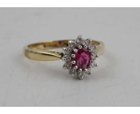 An 18ct gold ruby and diamond cluster ring, weight 3.7g