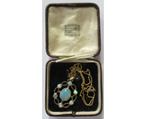 A white metal openwork pendant, set with oval cabochon opal to the centre and a further six small opals to the border, on a y