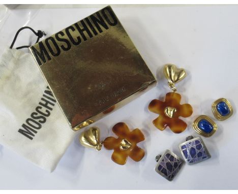 A pair of Christian Dior simulated lapis lazuli earrings, together with a pair of Moschino earrings, in pouch and box and a p
