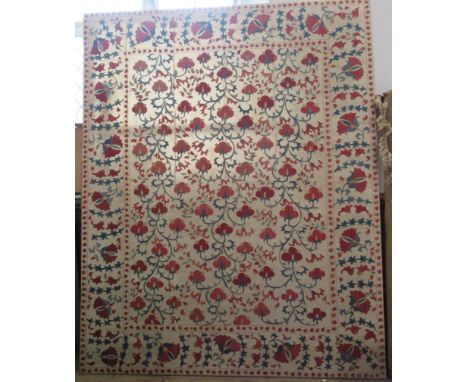 A large tapestry, in the Persian style with red and blue flowers and leaves, 106ins x 85ins
