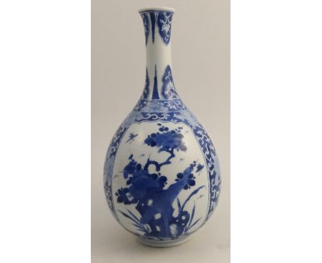 A Chinese Kangxi vase, decorated with panels of foliage with flower head reserves, bearing a Marchant &amp; Sons label to the