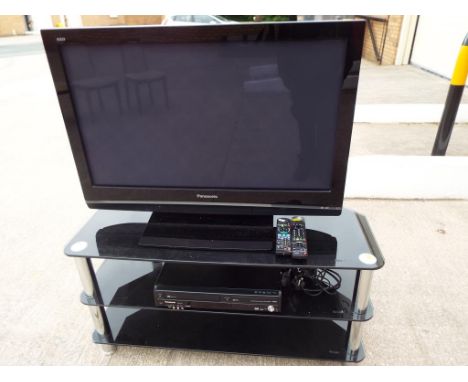 A 36 inch Panasonic flat screen TV model no. TH - 37PX80BA also included in the lot is a modern glass display stand and a Pan