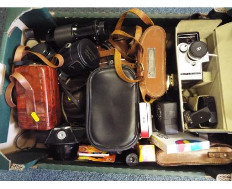 A good lot of photographic equipment to include a vintage Bell & Howell auto load cine film camera in case, a Revere eight in