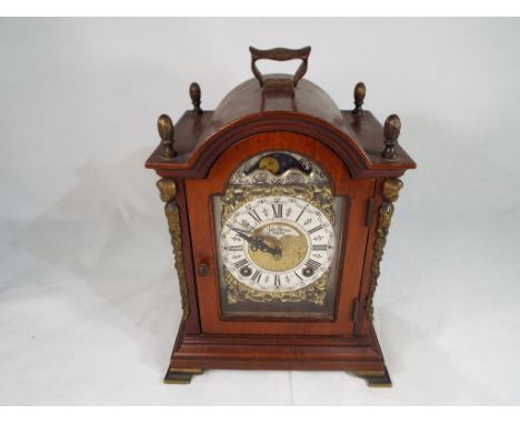 A reproduction George II style mahogany bracket clock by Wuba, the silvered and gilded metal dial with moonphase arch, striki