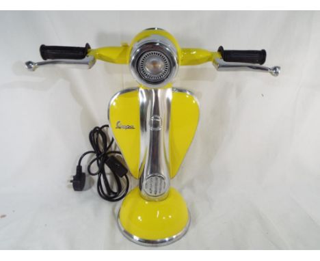 An unusual table lamp in the form of a Vespa scooter 42 cm (h). Estimate £70 - £100