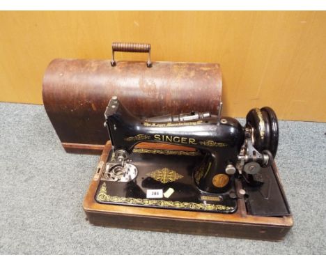 A good quality Singer sewing machine model No. EF633371 with wooden arch top case
