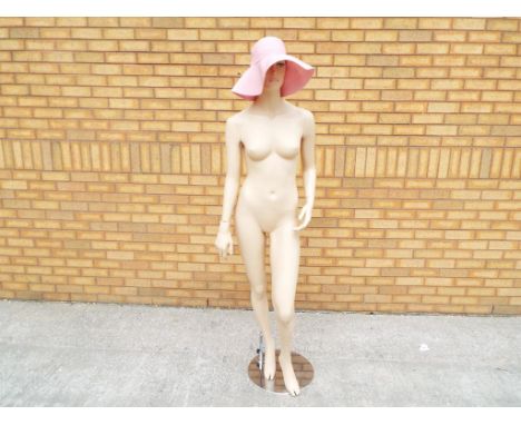 A full size window mannequin with chrome stand model number ULN - 07 - T.