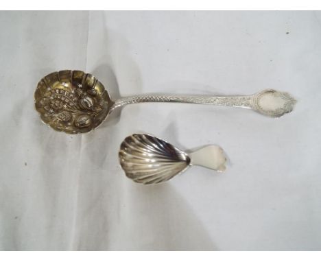 A silver caddy spoon and a silver highly decorated sifter, overall weight 44 grams. Estimate £30 - £50