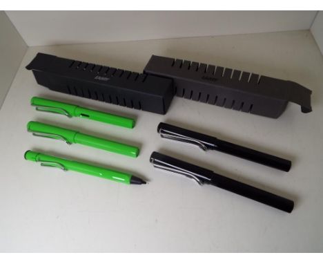 Lamy Safari - a green pen, pencil and rollerball writing set, and a black pen and rollerball set, boxed