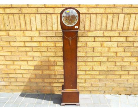A granddaughter clock, oak cased Art Deco style, Smiths three train Westminster chiming movement, with key and pendulum Est £