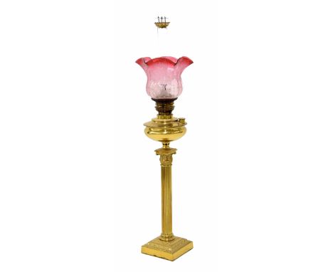 Victorian brass Corinthian column oil lamp, with a graduated cranberry etched glass shade 