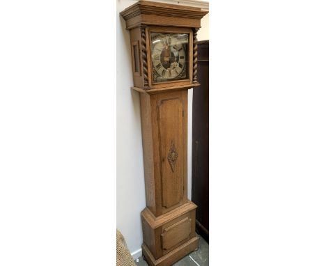 An oak cased long case clock, the dial with silvered chapter ring and Roman numerals, flanked by barleytwist columns, 188cmH 