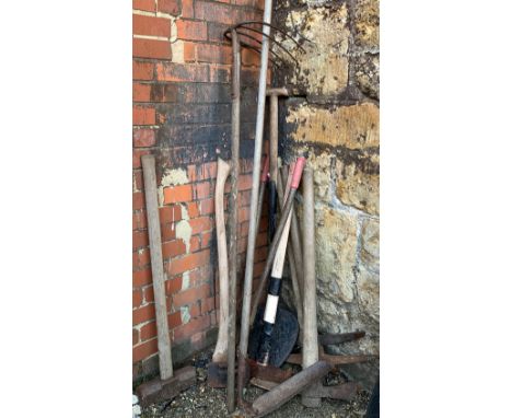 A quantity of garden tools to include sledge hammer, picks, bolt cutters, etc 