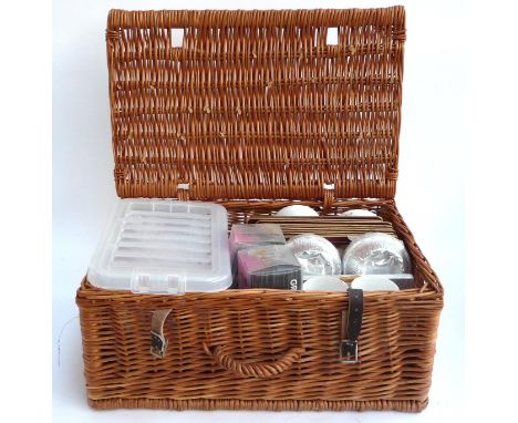 A wicker picnic hamper, 53cmW, containing a quantity of cutlery, straws, place mats, ramekins etc 