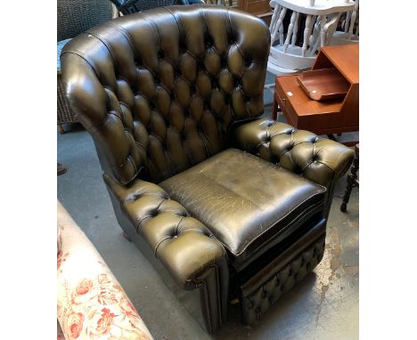 A button back faux green leather reclining armchair 