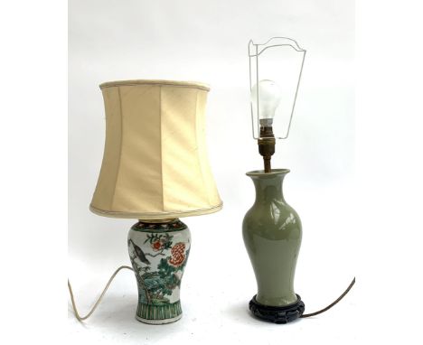A baluster form table lamp decorated with images of a bird amongst foliage, together with one other olive green table lamp on