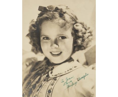 * Temple (Shirley, 1928-2014). Signed photograph, c.1936, vintage matte-finish head and shoulders publicity photograph of the