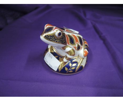 A ceramic paper weight by Royal Crown Derby Frog having seal stamp to base