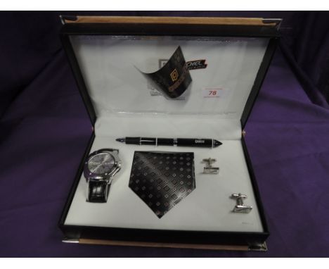 A cased gents set by QBOS consisting of a wrist watch, tie, pen and cufflinks