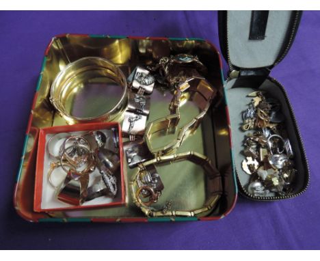 A tin of costume jewellery including earrings, cufflinks, rings, bracelets etc