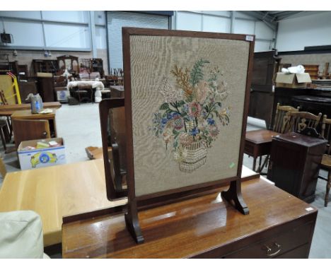 An embroidered firescreen