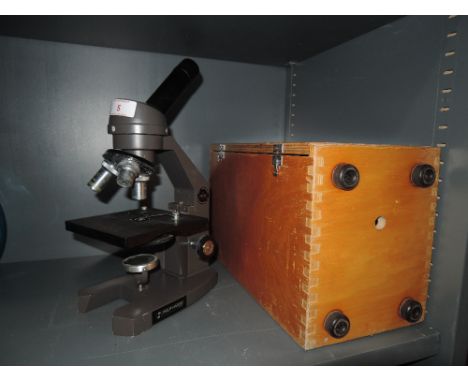 A scientific microscope by Swift instruments with fitted case and slides