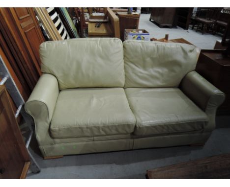 A late 20th/early 21st Century cream leather sofa