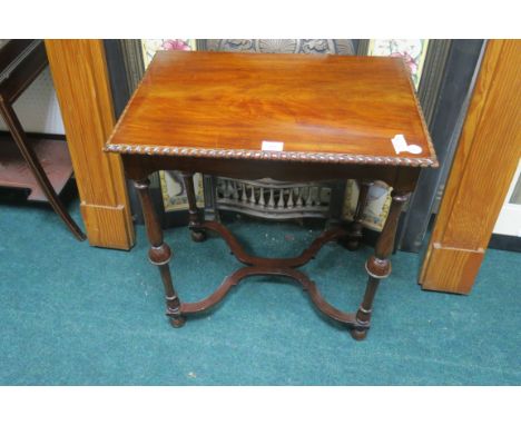 A CHIPPENDALE STYLE MAHOGANY OCCASSIONAL TABLE, the rectangular top with gadrooned rim raised on baluster legs joined by shap