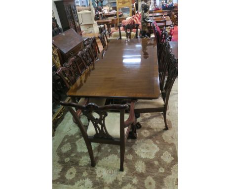 AN ELEVEN PIECE MAHOGANY DINING ROOM SUITE, comprising ten Chippendale style chairs including a pair of elbow chairs each wit