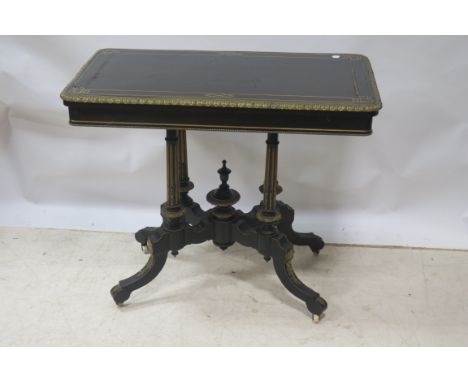 A LATE 19TH CENTURY EBONISED AND GILT BRASS MOUNTED FOLDOVER TOP CARD TABLE, the rectangular top with Grecian style border an