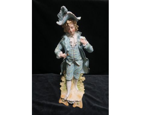 A PAINTED PARIAN FIGURE, of an 18th century dandy shown standing by a tree stump on a regular base with bracket ends 43cms hi