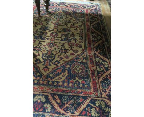 A PAIR OF WOOL RUGS, each with a light brown wine and grey ground with stylised foliate decoration each 200cms x 130cms