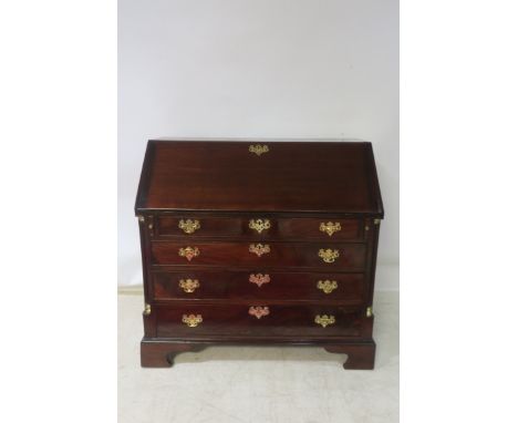 A GEORGIAN STYLE MAHOGANY FRAMED BUREAU, the forefront opening to reveal a green baize interior with an arrangement of pigeon