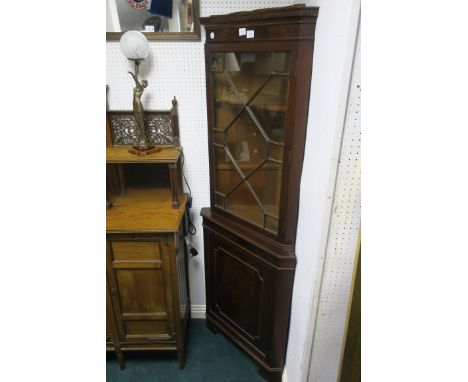 A GEORGIAN STYLE MAHOGANY FRAMED CORNER CABINET, the dentil cornice above an astragal glazed door with outset base cupboard d